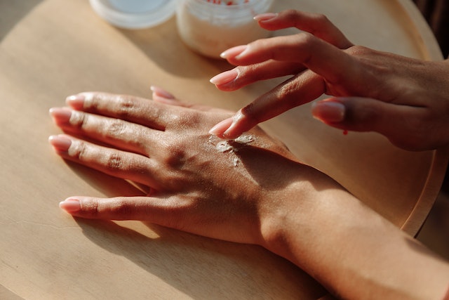 close up of hands rubbing cream in